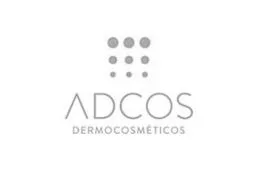 Logotipo da ADCOS Dermocosméticos. O design apresenta o nome da marca "ADCOS" em letras maiúsculas com "DERMOCOSMÉTICOS" escrito abaixo em letras maiúsculas menores. Acima do texto, há uma grade de nove pontos dispostos em um padrão quadrado.